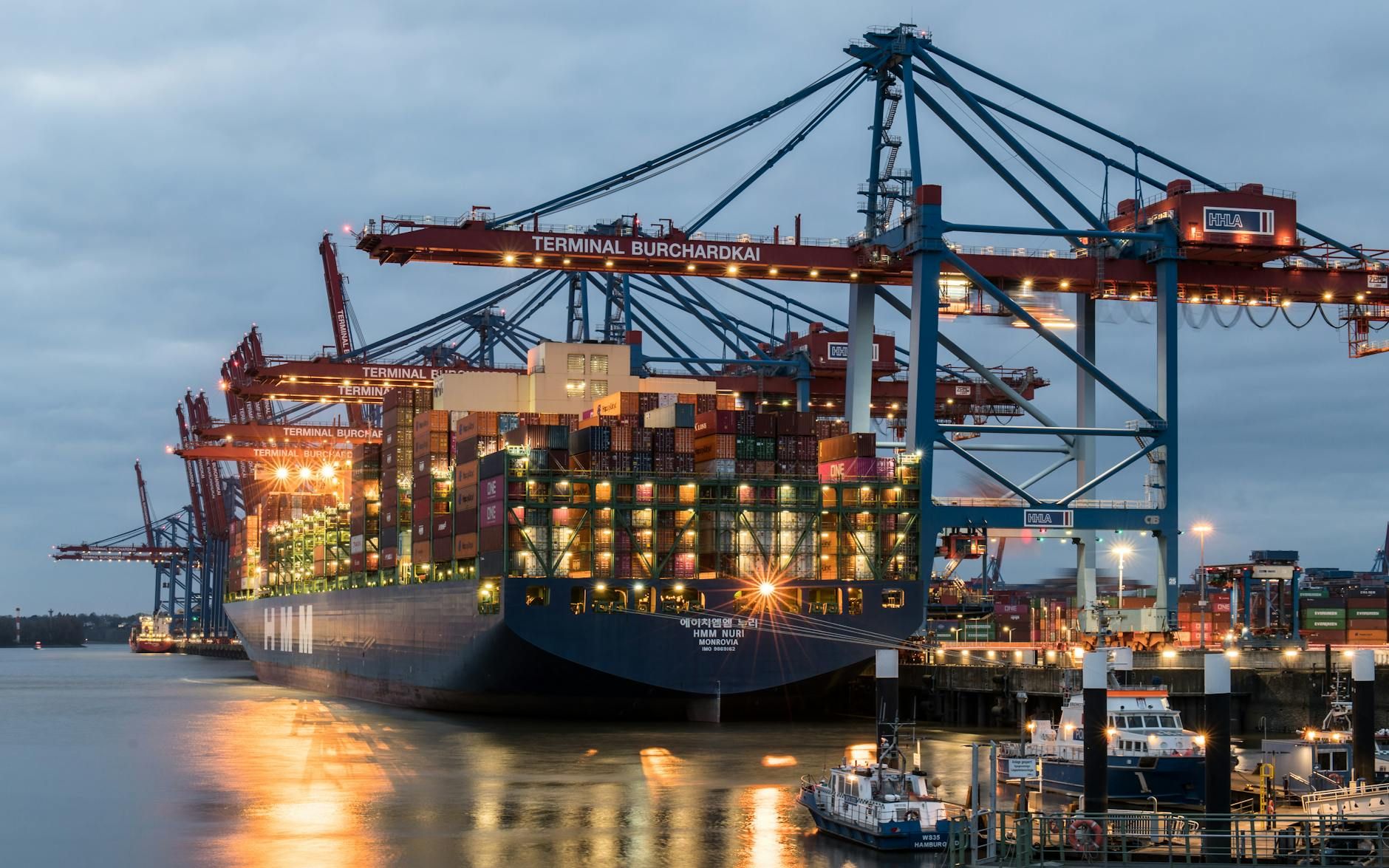 Container terminal with cranes illuminated at dusk