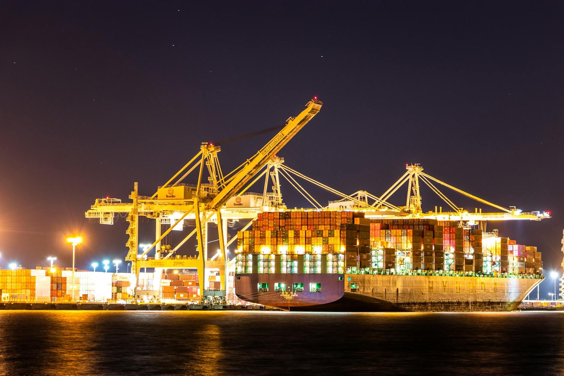 Wide aerial view of a shipping port at night